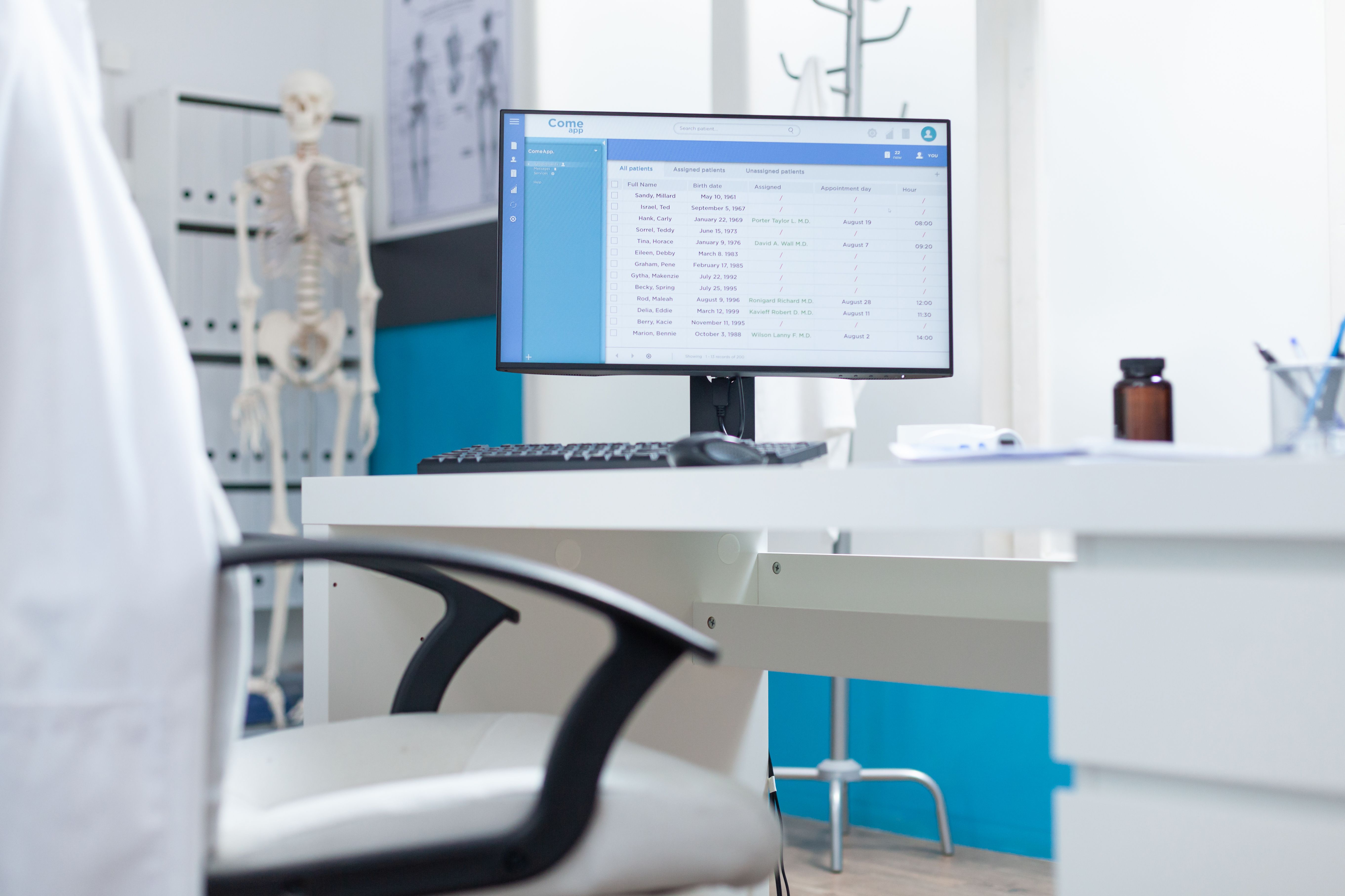 computer-with-medical-patient-files-screen-standing-table-empty-doctors-office-medical-examination-hospital-office-equipped-with-professional-modern-furniture-health-care-support