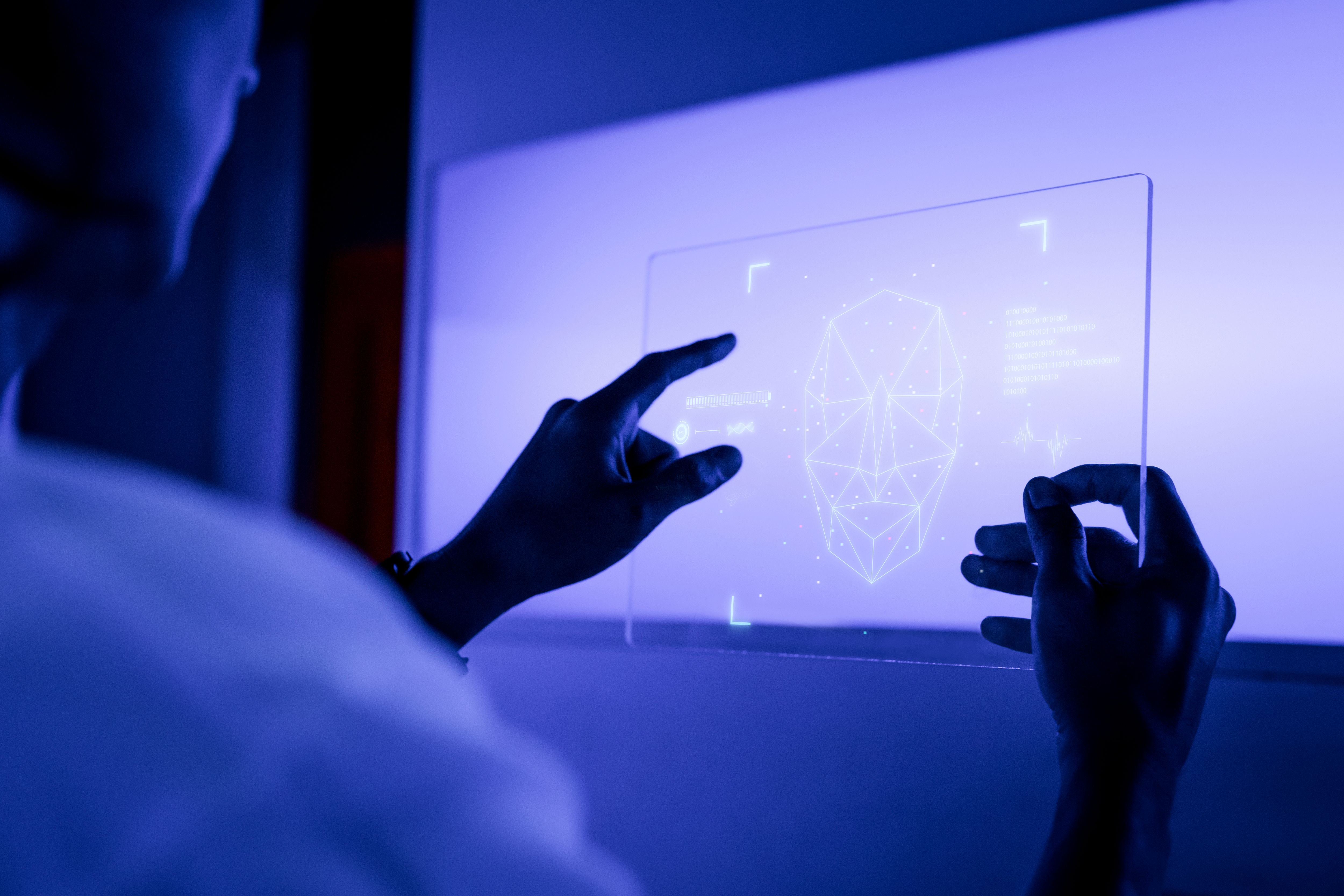 designer-using-transparent-digital-tablet-screen-futuristic-technology