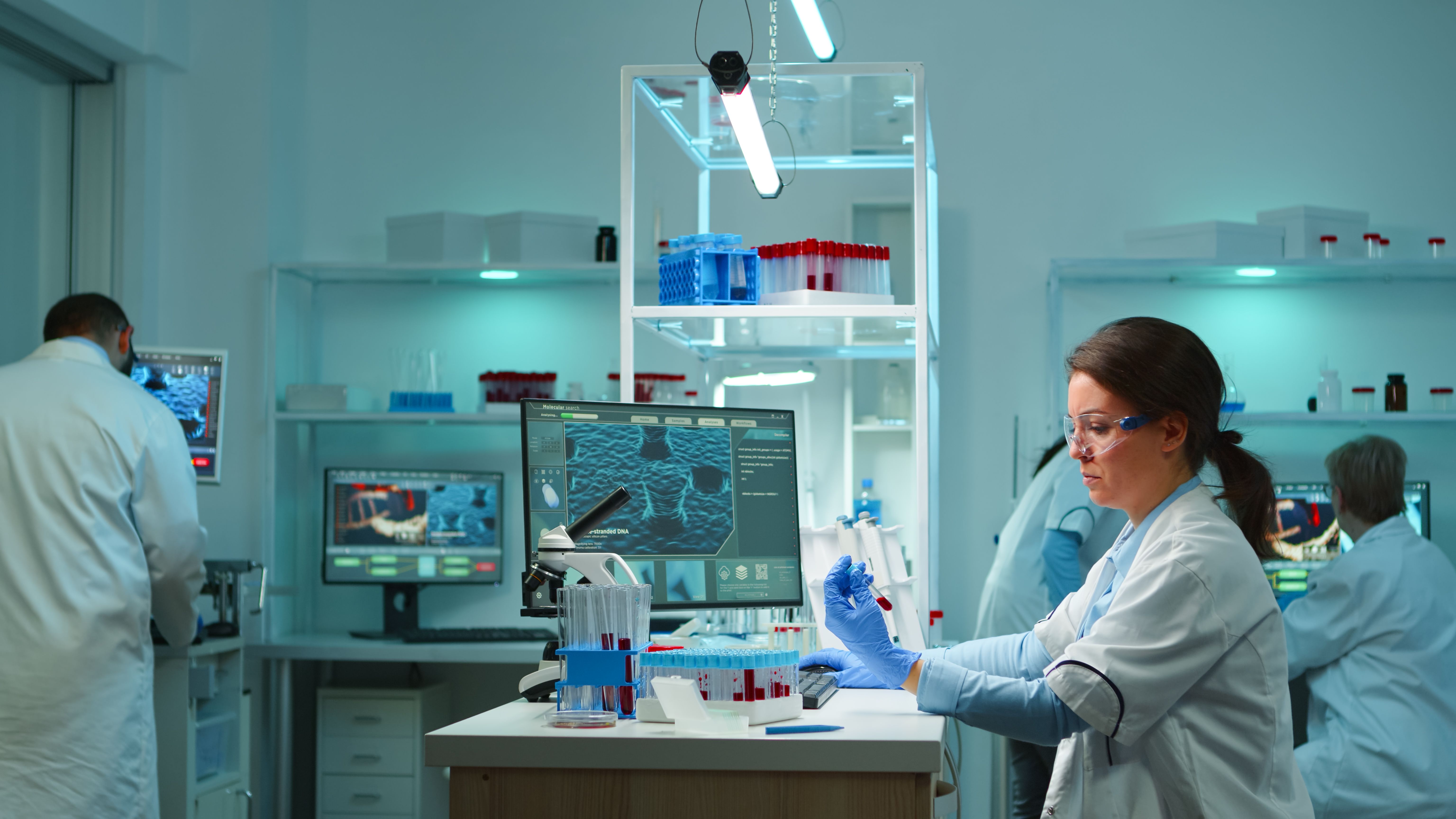 medical-lab-worker-analyzing-blood-serum-conducting-virus-test-modern-equipped-lab-late-night-team-specialists-examining-vaccine-evolution-using-high-tech-treatment-against-covid19